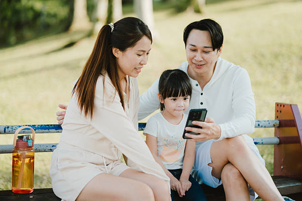istock Family bonding time with smartphone in park 2225992338
