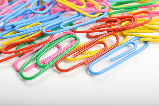 Pile of colorful paper clips isolated on white background