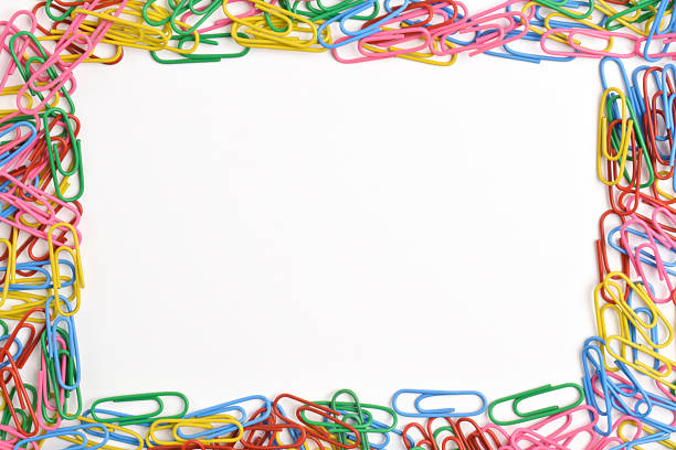 istock Colorful paper clips frame a white background 2225998325
