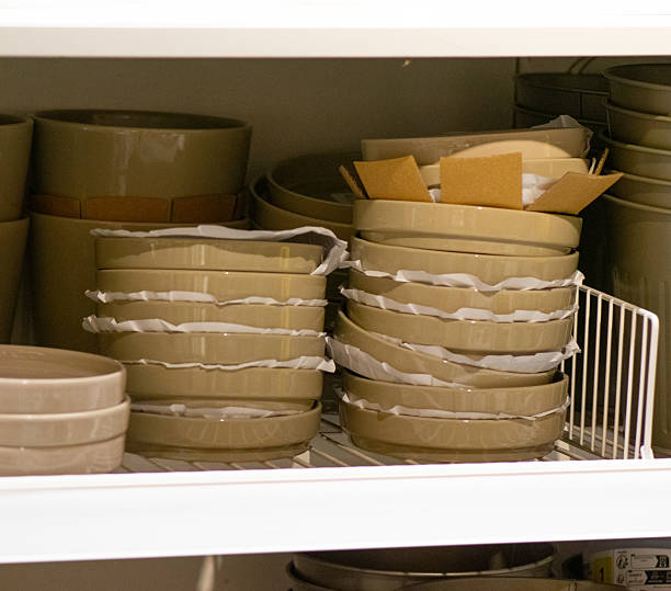 istock Bulk stacks of neutral ceramic plates, bowls and mugs in retail warehouse display 2226000543