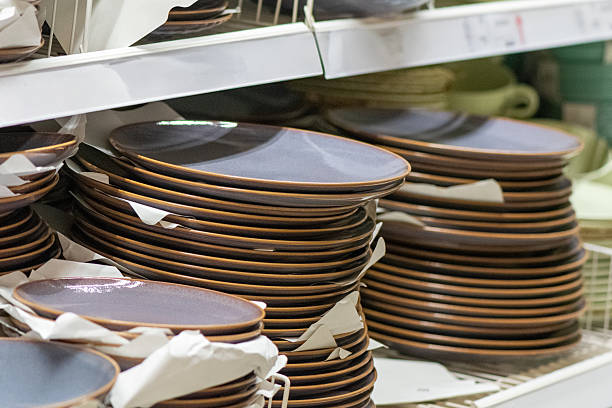 istock Stacks of matte grey-blue stoneware dinner plates on retail shelf 2226000554