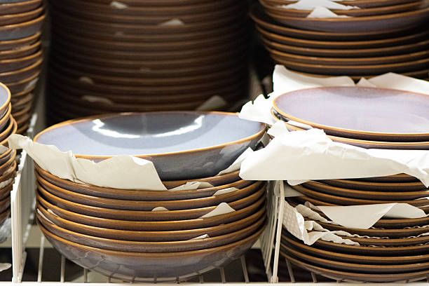 istock Stacks of matte grey-blue stoneware dinner plates on retail shelf 2226000573