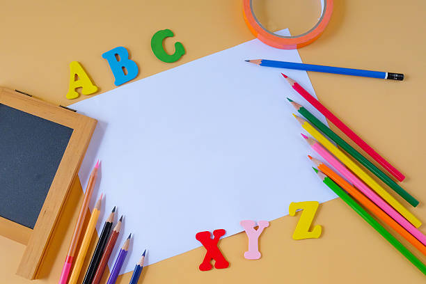 istock Colored pencils and blank paper sheet on color background . 2226001820