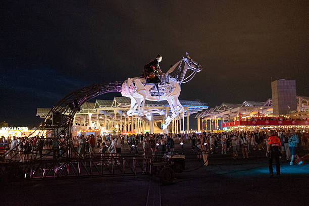 Barcelona, España July 12, 2025. Giant mechanical horse carrying a woman captivates a vibrant crowd, performing under dazzling lights at a lively festival celebration in Cruilla Festival, Barcelona.