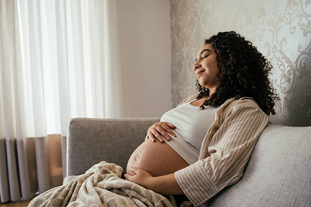 istock Pregnant woman relaxing on the sofa 2226003874