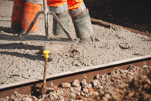 istock Close-up of Builder uses spazzle to evenly level freshly mixed concrete on construction site ensuring smooth and durable surface 2226004530