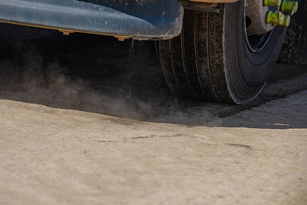 istock A street sweeper operates along a dirt road, using its bristles to remove dust and debris in an urban setting under bright sunlight, enhancing cleanliness in the area. 2226005434