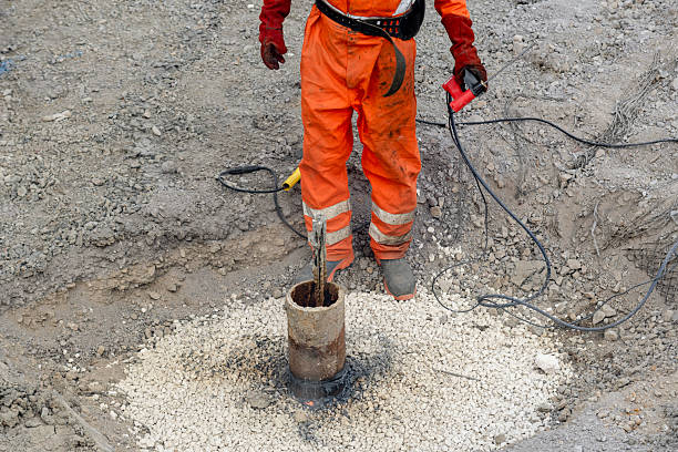 istock Welder using welding equipment to cut off steel pile on construction site creating fire arc of hot molten steel, sparks and smoke around 2226005436