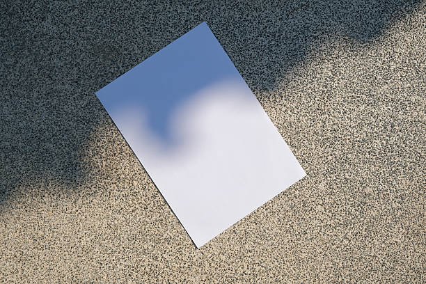 istock empty vertical paper poster mockup on concrete stone floor or pavement outdoors, shadow overlay 2226005643