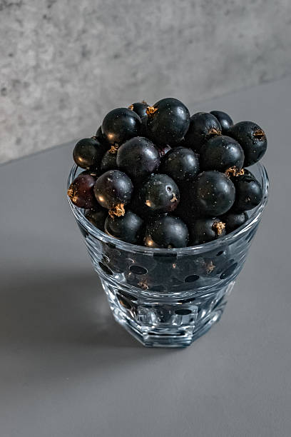 istock Glass filled with ripe blackcurrants 2226010257