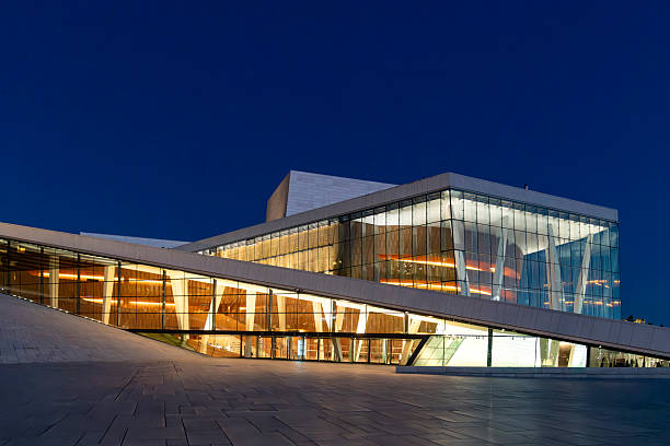 Oslo, Norway-25 September 2024; Evening view with illuminated Oslo Opera House (Operahuset) home of the Norwegian National Opera and Ballet at head of the Oslofjord