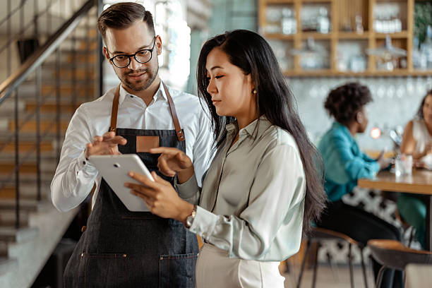 istock Coffee Shop Manager Instructing Employee on Digital System 2226020242