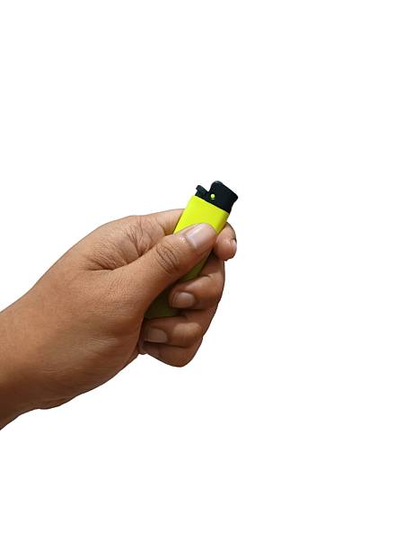 istock hand holding a yellow color gas lighter. 2226030981