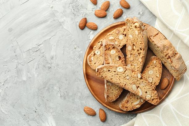istock Traditional Italian almond biscuits (Cantucci) and nuts on grey textured table, flat lay. Space for text 2226032354