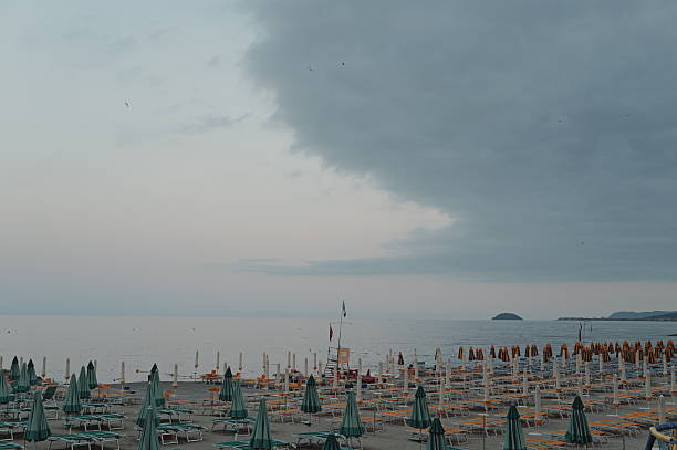 sunset on the beach with all the umbrellas closed