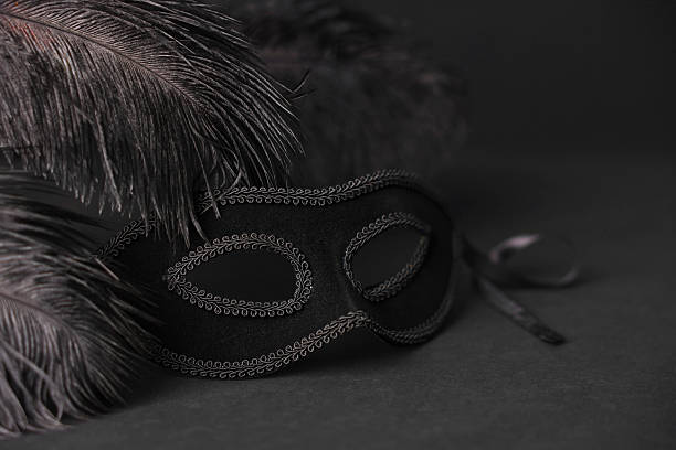 istock Beautiful carnival mask and feathers on black background, closeup 2226033874