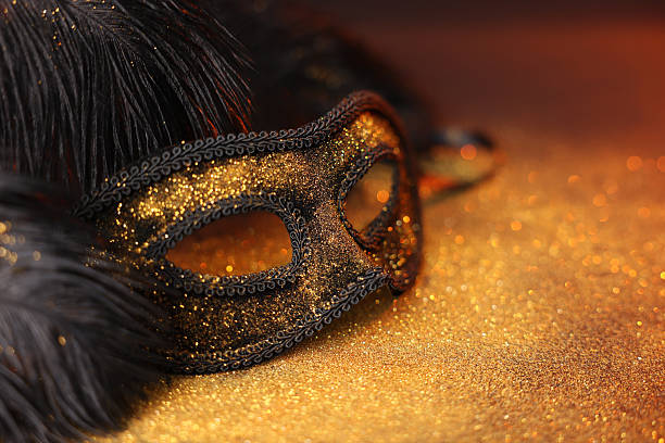 istock Beautiful carnival mask and black feathers on glitter background, closeup. Space for text 2226033924