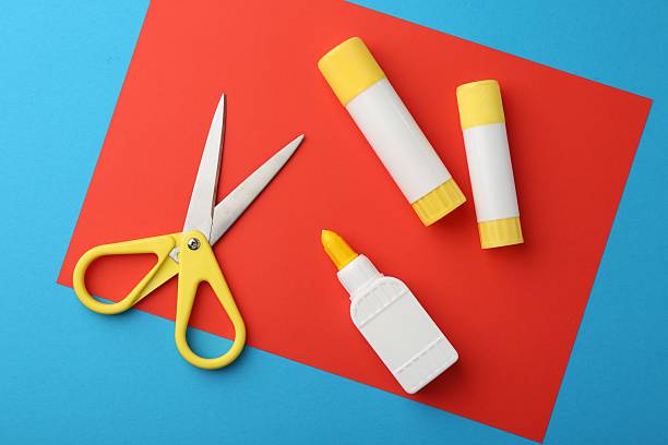 istock Glue, colorful paper and scissors on light blue background, flat lay 2226033983