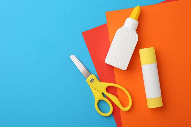 istock Glue, colorful paper and scissors on light blue background, flat lay. Space for text 2226034010