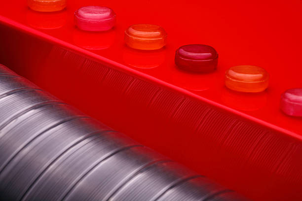 Cropped Hand Holding Candy Over Red Fabric