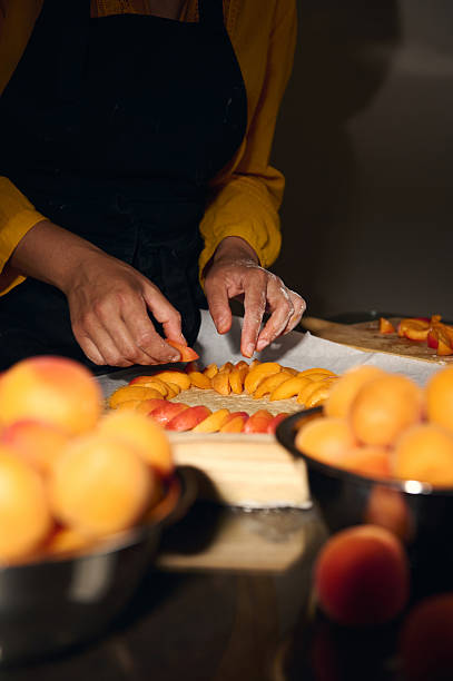 istock Woman Preparing Pastry with Fresh Apricots in a Culinary Setup 2226040183
