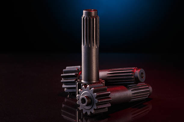 istock Three metallic shafts rest on a dark glossy surface 2226043733