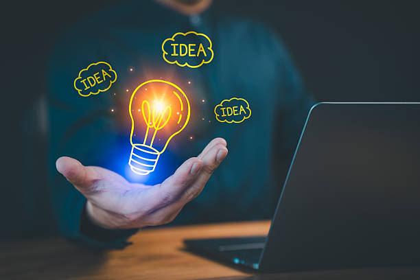 Person presenting a glowing lightbulb icon and 