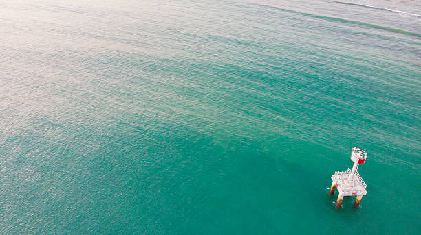 istock Solitary ocean lighthouse captured from above, surrounded by endless blue water. 2226049480