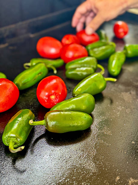 istock Brightly colored tomatoes and jalapenos on a grill 2226054416