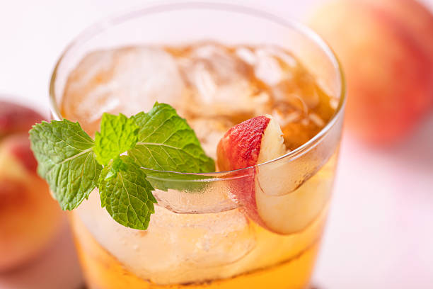 Iced peach tea with fresh sliced peaches and mint leaf, Summer drink