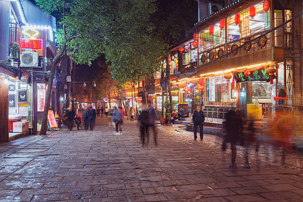 Fenghuang County, China - November 13, 2016: Cafe, shops and historical buildings at evening time.