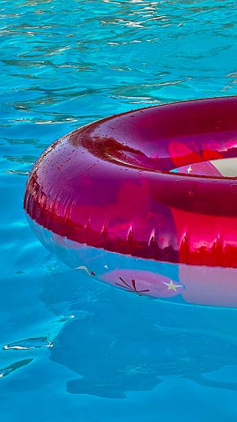 istock Vertical Image Pink Inflatable Floating on Still Blue Water 2226055486