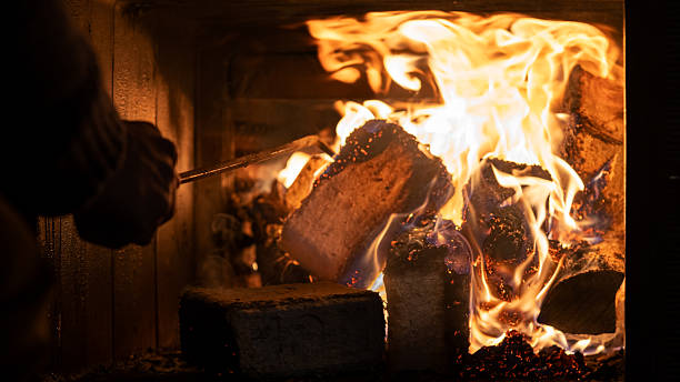 istock Eco-friendly compressed wood briquettes ignite a warm, inviting fire in a modern stove, showcasing sustainable heating and cozy ambiance for any home 2226057912