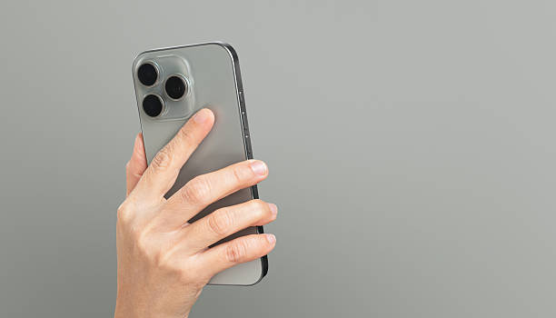 istock Clipping path, Hand holding the smartphone on grey background. 2226061744