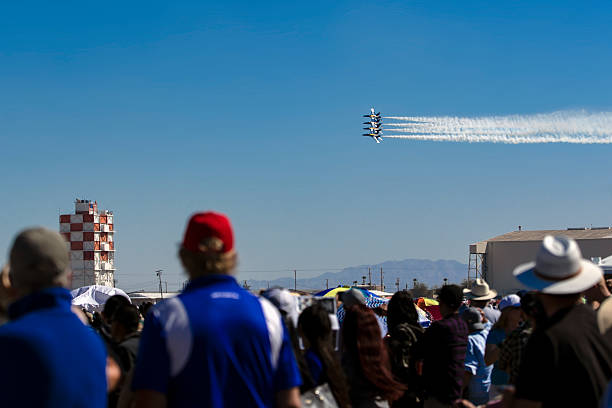 Blue Angels flying in formation and low as crowd of people watch, air show at El Centro, California on March 16, 2019.