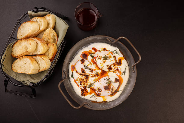 istock Cilbir or Turkish Eggs is Poached Eggs With Creamy Yogurt and Butter Sauce. 2226080153