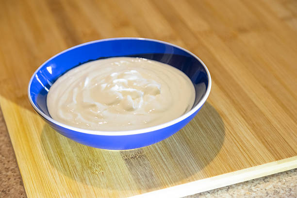 A bowl full of natural yogurt on the table