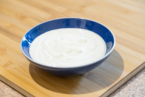 A bowl full of natural yogurt on the table