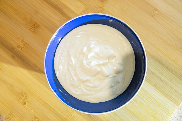 A bowl full of natural yogurt on the table