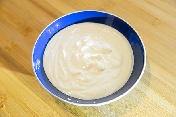 A bowl full of natural yogurt on the table