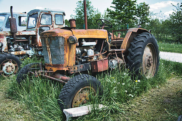 istock Rusty Vintage Tractors Abandoned in Overgrown Field 2226090901
