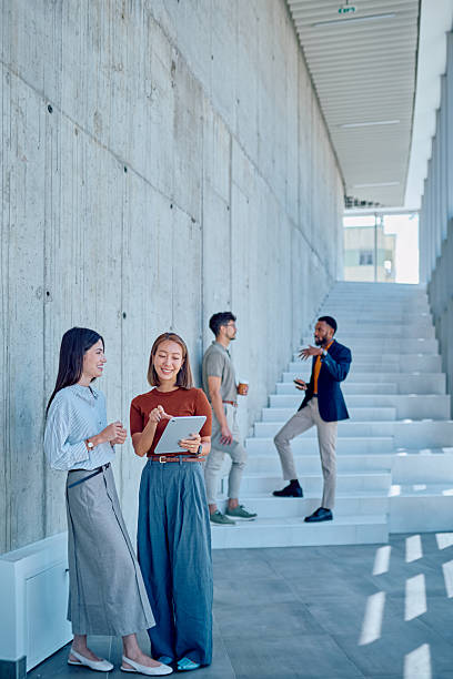 istock Businesswomen using tablet and discussing work in modern office building 2226095958
