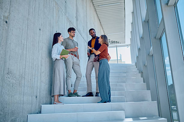 istock Businesspeople talking on stairs during coffee break 2226096005
