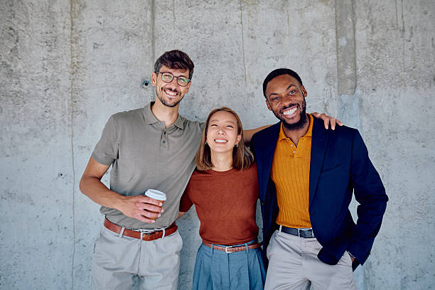 istock Happy multi-ethnic business team smiling with arms around each other 2226096154