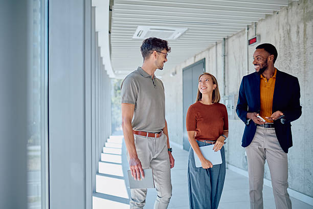 istock Businesspeople walking and talking in office corridor 2226096302