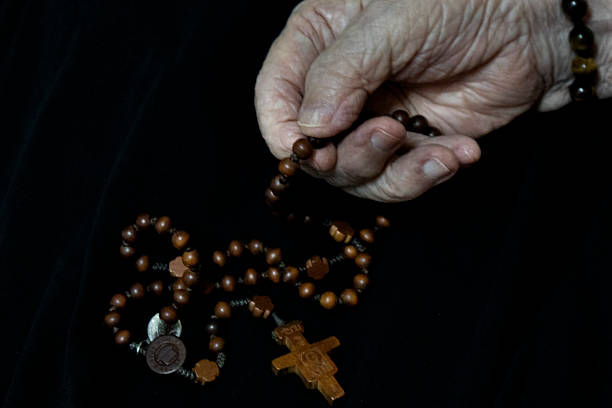 Priest praying on cementery at burial.