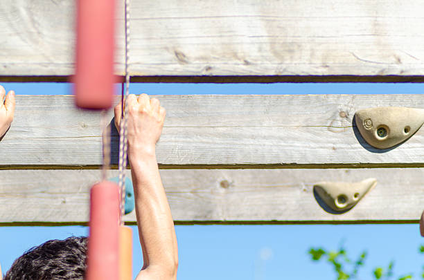 Athlete seen from behind training on an outdoor obstacle course