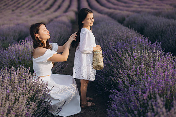 istock Mother combing her daughter's hair in a lavender field 2226098107