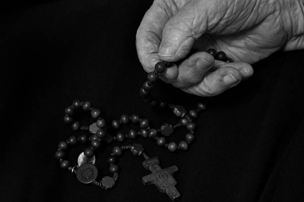 istock My mother is praying the rosary.  . 2226098626