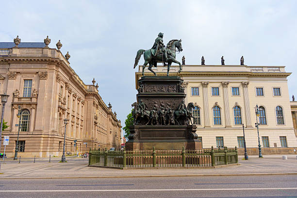 Berlin, Germany - June 1, 2025: Equestrian statue of Frederick the Great surrounded by historic buildings in Berlin. Details include bronze sculpture, ornate architecture, and city ambiance.